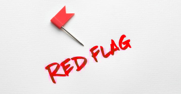 A graphic of a red flag on a white background with writing underneath that reads 