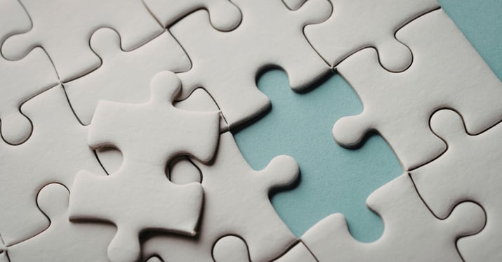 a photo of a white puzzle missing one piece