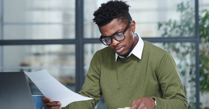 A photo of a guy looking through proposals